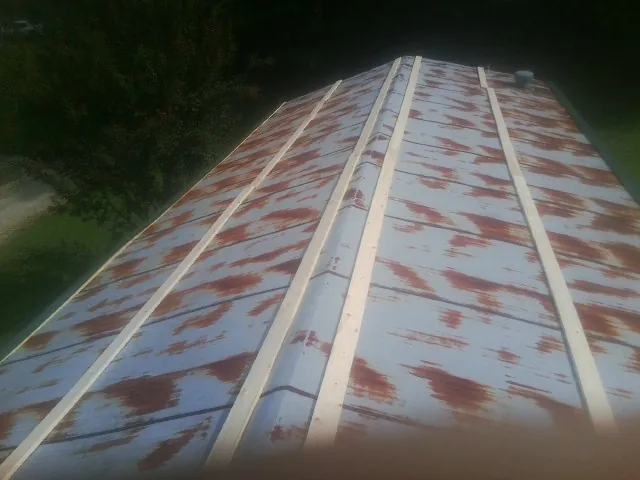 Rusted metal roof panels with new wood purlins before replacement — Storm Damage Roof Repair in Beecher by Roofing Brothers